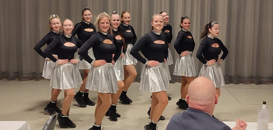 Young women dancing in the same outfit.